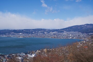 Naklejka na ściany i meble The view of Lake Suwa with cloud in winter.