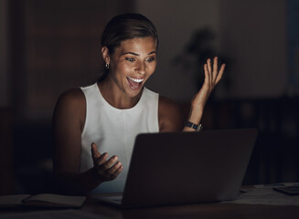 Her time was worth every dime. Shot of a young businesswoman using a laptop and looking surprised during a late night at work.