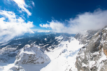 Fototapeta na wymiar The snowy winter panorama of the Dachstein Alps. The Dachstein is the highest mountain in Upper Austria, Styria. Eternal ice in the Alps. Winter vacation