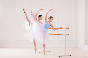 Young ballerinas having rehearsal at studio. Row of happy young ballerinas practicing at ballet...
