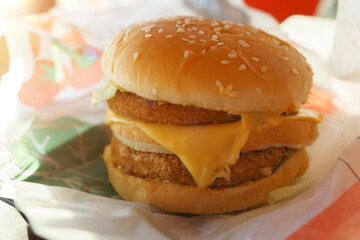 Cheeseburger with double cutlet close-up in a fast food restaurant