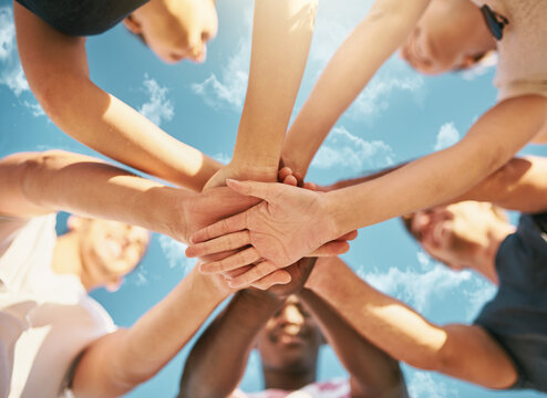 Nothing beats the bond of true friendship. Low angle shot of a group of young joining their hands together in solidarity. © Lyndon S/peopleimages.com