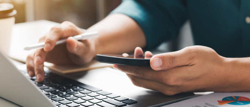 businessman working using mobile phones and laptop computers Liaise with customers and plan business strategies, working concepts using technology in the most efficient way.