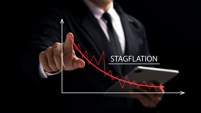 The concept of the collapse of the stalled economy. Inflation risk. The graph shows the recession, the male businessman touches the red downward curve.