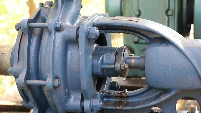 Centrifugal water pump in working condition used to pump water for agricultural purposes driven by a diesel-powered engine