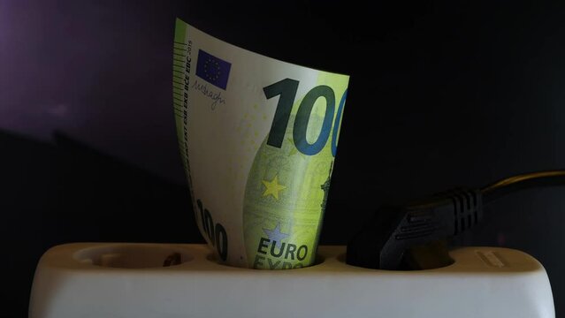 Concept for electricity price increase because of the energy crisis with a 100 euro note