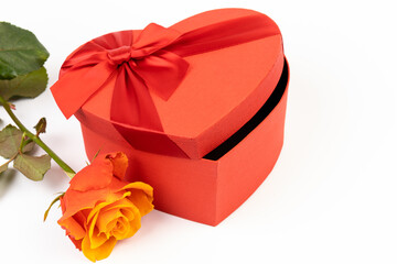 Red box in shape of heart. Gift box for Valentine's Day whith rose. Isolated on white background.