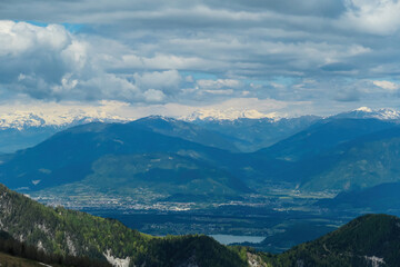 Fototapeta na wymiar Mountain peak of Hahnkogel (Klek) with panoramic view in spring on the Karawanks, Carinthia, Austria. Borders Austria, Slovenia, Italy. Hohe Tauern Mountain Range. Alpine meadows