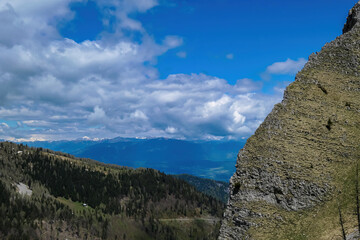 Mountain peak of Hahnkogel (Klek) with panoramic view in spring in the Karawanks, Carinthia, Austria. Borders Austria, Slovenia, Italy. Triglav National Park. Alpine meadows. Alm. Snow fields melting
