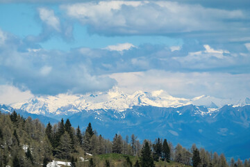 Mountain peak of Hahnkogel (Klek) with panoramic view in spring on the Karawanks, Carinthia, Austria. Borders Austria, Slovenia, Italy. Triglav National Park. Alpine meadows. High grass