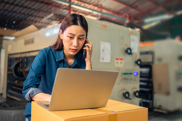 Business or owner or entrepreneur work in stock or warehouse industrial, businessman and woman use laptop computer or tablet for check inventory and logistic management.