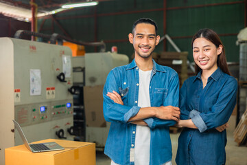 Obraz premium Couple asian entrepreneur work in stock or warehouse industrial, businessman and woman use laptop computer or tablet for check inventory and logistic management.