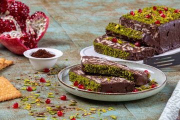Mosaic cake. Pomegranate and green pistachio, biscuit and chocolate cake. Traditional, homemade, cocoa mosaic cake