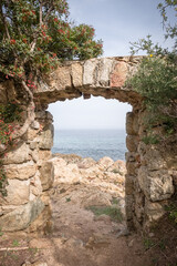 Fototapeta na wymiar A stone doorway with a view through to the Mediterranean sea at Davia on the west coast of Corsica