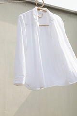 White shirt hanging to dry on clothes line