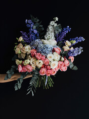 Bouquet of stylish flowers. Romantic composition with pink flowers. Pastel plants composition