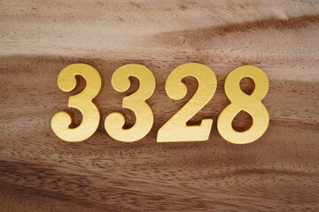 Golden Arabic numerals on a real brown and white wooden floor number 3328