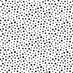 Hand drawn vector illustration of random black dot pattern on white background.
