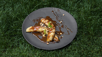 Grilled bananas. Photo of food on a dark background.