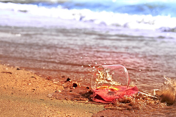 Wine glass with a cocktail by the sea.
