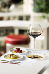Photograph of food on the table Romantic dinner, food and a glass of wine.