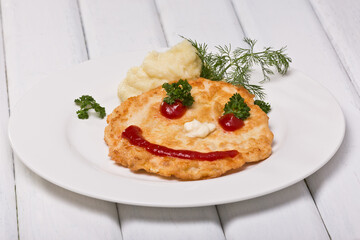 Children's cutlet, emoticon. Photo of food on a white background