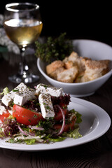 Greek salad, tomatoes and cheese. Food photography, dark background