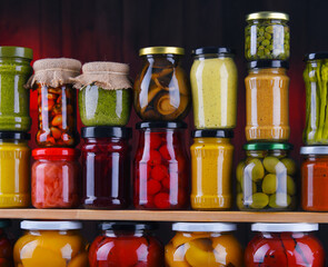 Jars with variety of pickled vegetables and fruits