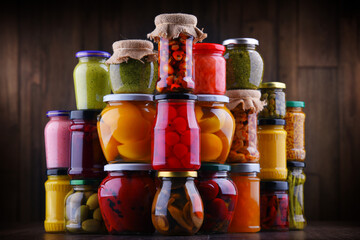 Jars with variety of pickled vegetables and fruits