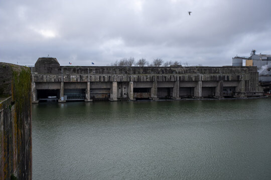 Saint Nazaire, France - March 2, 2022: German submarine base in Saint Nazaire. It's a fortified U-boot pens built by Germany during the Second World War. Cloudy winter day. Selective focus.