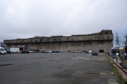 Saint Nazaire, France - March 2, 2022: German submarine base in Saint Nazaire. It's a fortified U-boot pens built by Germany during the Second World War. Cloudy winter day. Selective focus.