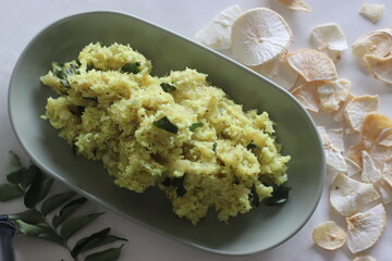 Mashed dry casava or dry tapioca. Boil the soaked dry tapioca and mash it with a mixture of grated coconut, shallots, chillies, turmeric and curry leaves