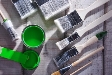 Paintbrushes of different size and paint can