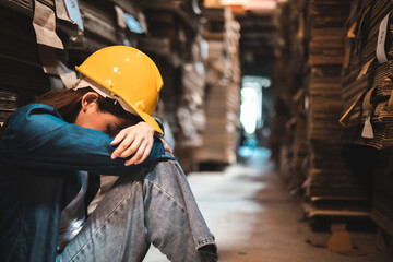 Asian Business owner sitting in factory plantation posing feel tried and serious with work.Engineer...