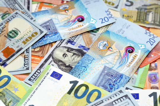 Kuwaiti dinar money with American dollars bills and European euros banknotes, selective focus of a pile of 20 twenty Kuwaiti dinars, 100 one hundred dollars and 100 one hundred euros exchange rate