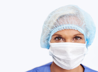 That was a successful surgery. A portrait of a young doctor in her scrubs and mask.