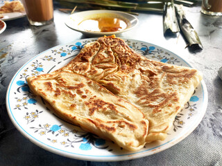 Traditional Malaysian signature flatbread food is called roti canai.  This is type of pancake made from mix of flour, egg and water. Eat with special sauce.
