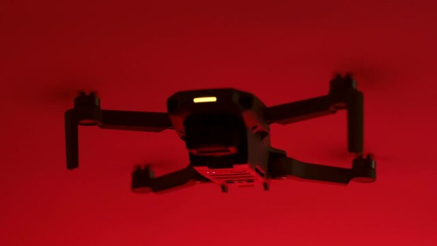 Silhouette Close up footage of a drone on a red background.