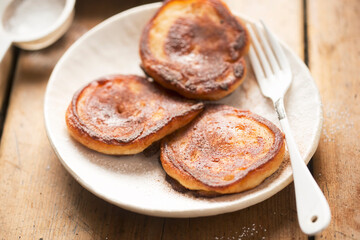 Pancakes with apples, cinnamon and icing sugar 
