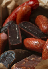 Cold meats, smoked and cured sausage, smoked meat, sausage in  wooden box. rustic style .