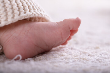 New Born Baby Feet on White Blanket