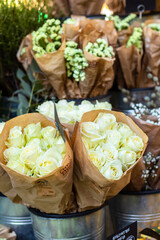 Flower business. Flowers are white in kraft paper standing on the counter. hochland rose