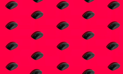 Isolated computer mouse on red background with hard shadow. 