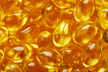Golden Vitamin D3 Capsules close-up in full screen