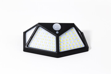 
Solar-powered wireless light. A modern and economical type of street lighting. Convenient wall lamp. The lantern is powered by solar panels. White background.