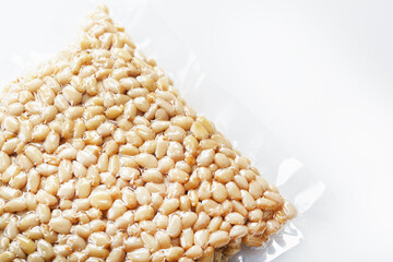 Pine nuts in a transparent vacuum package over