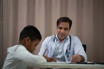 A doctor at an international hospital Trying to check up of a mischievous child