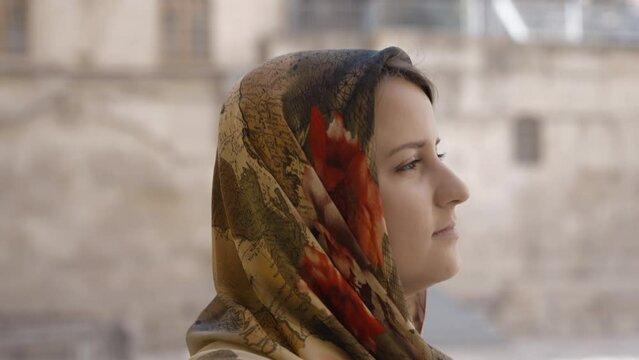 Woman in traditional clothes walking on the streets of Old Jerusalem. Slow motion, close up. 