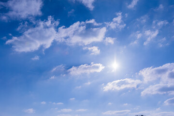 blue sky with sun and clouds