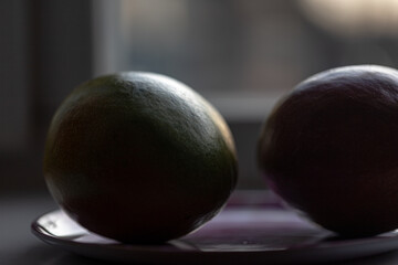 green red ripe mango on the windowsill